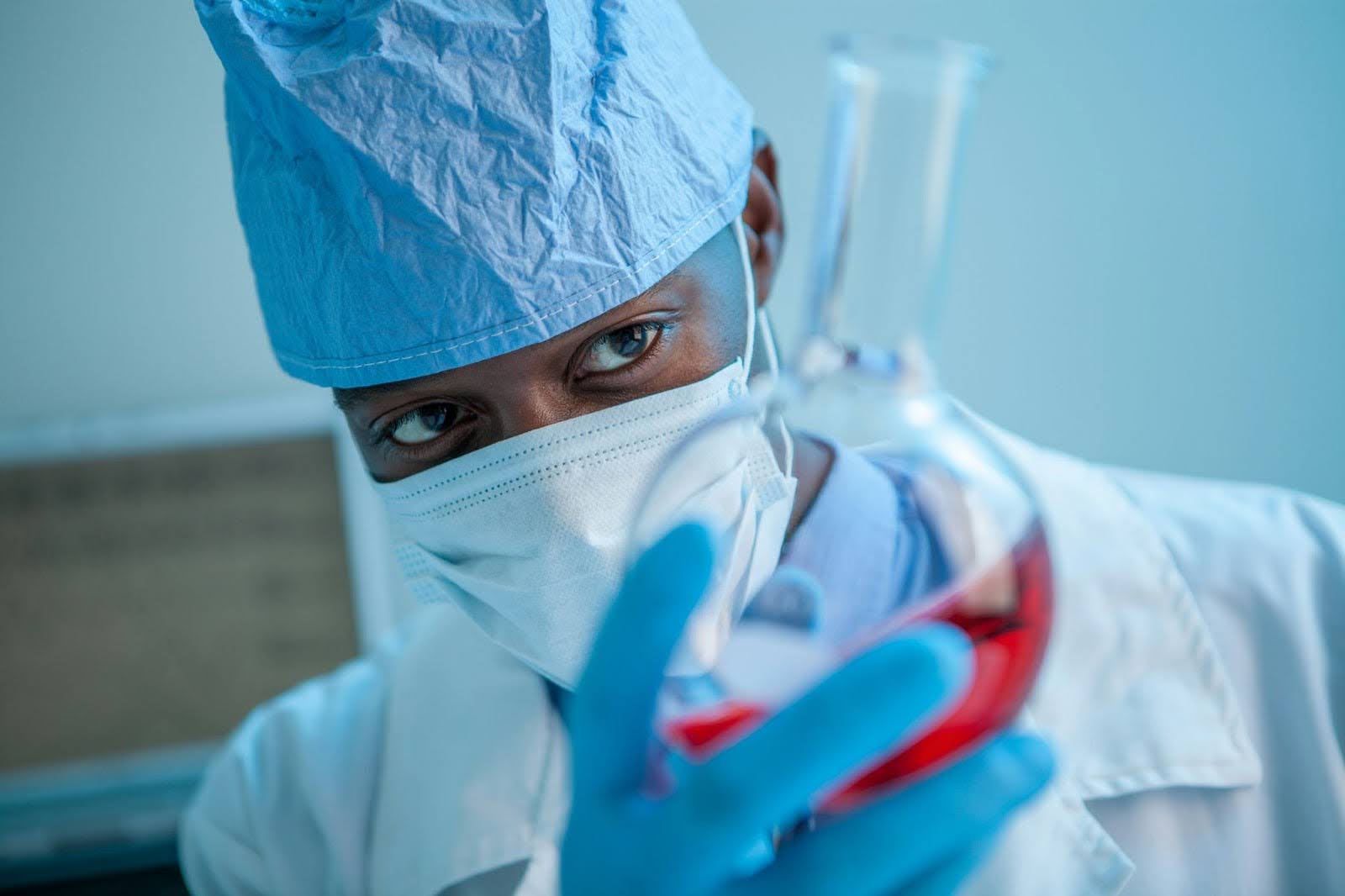 Dominican doctor looking at a flask